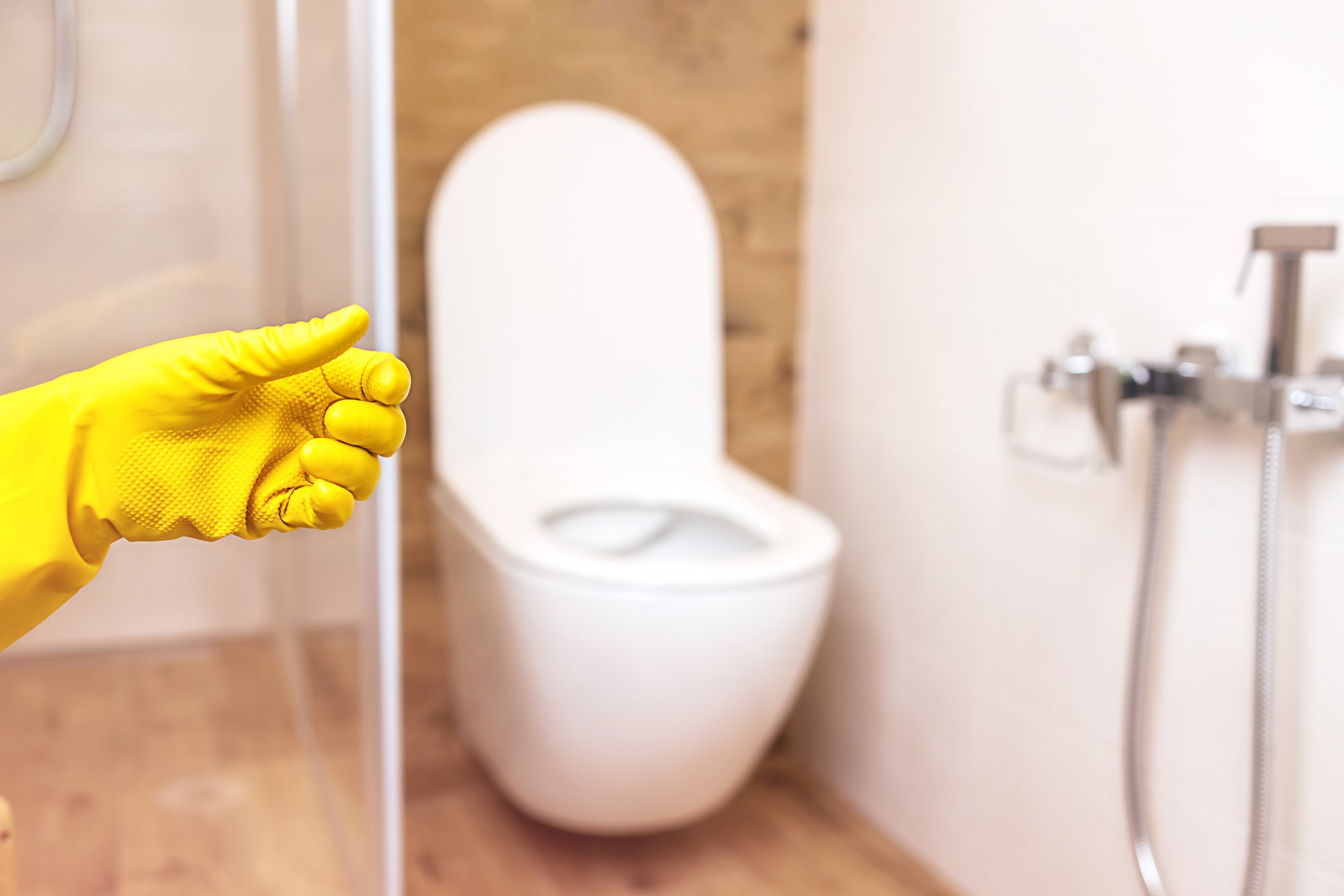 product-bottle-mockup-2-hands-protective-yellow-gloves-bathroom-background.jpg
